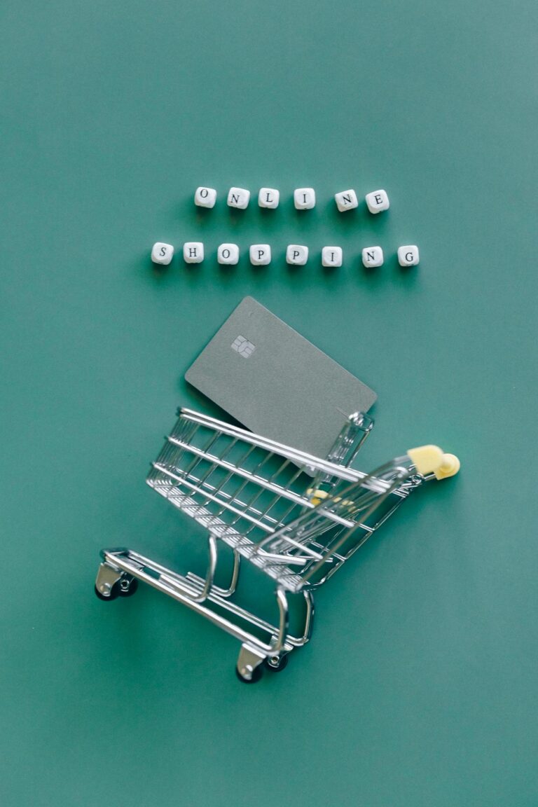 A miniature shopping cart with a credit card illustrates online shopping trends.